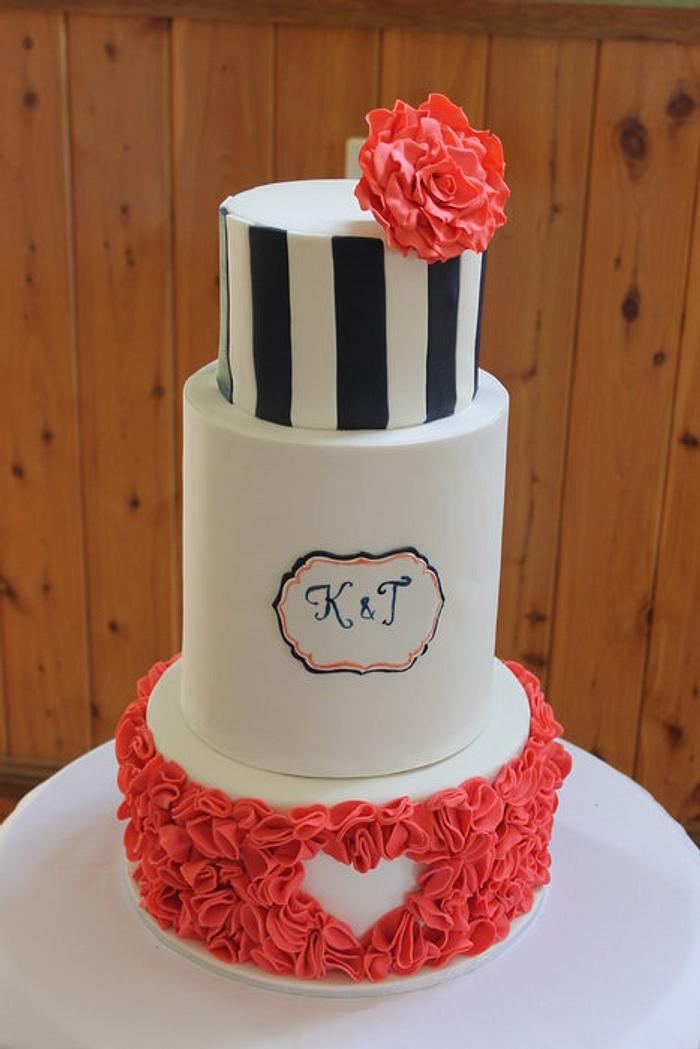 Coral, navy and white wedding cake