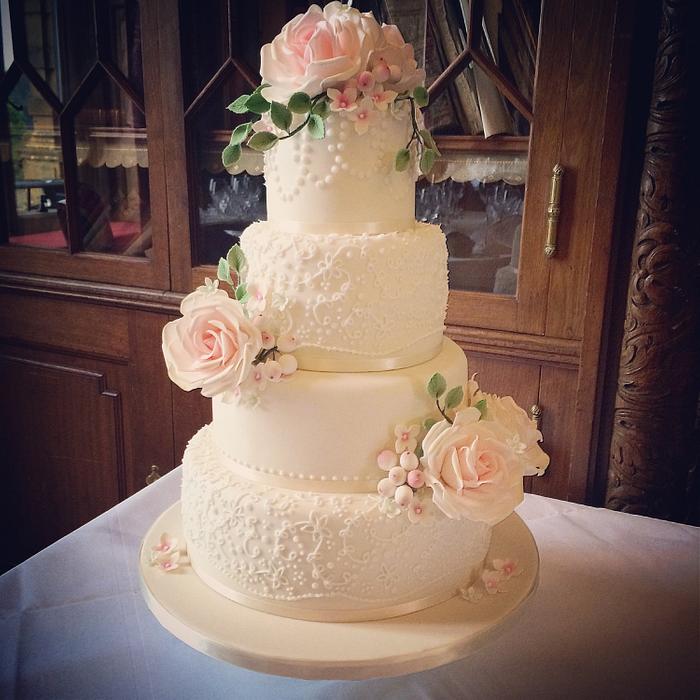 Vintage lace and rose wedding cake with snowberries  