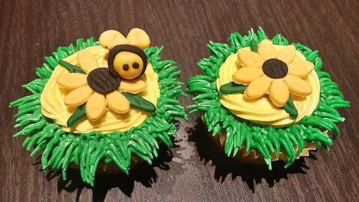 Sunflower cupcakes with a few bee invaders