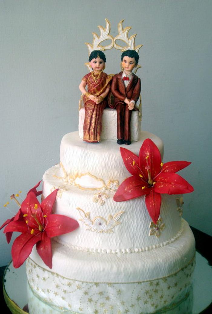 Wedding cake with bride in saree.