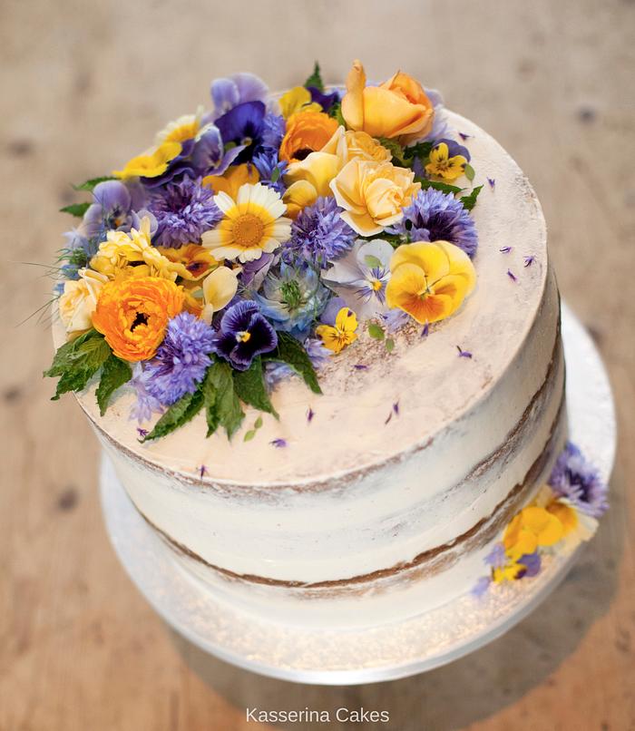 Large single tier, semi-naked carrot cake with fresh "edible grade" organic flowers.