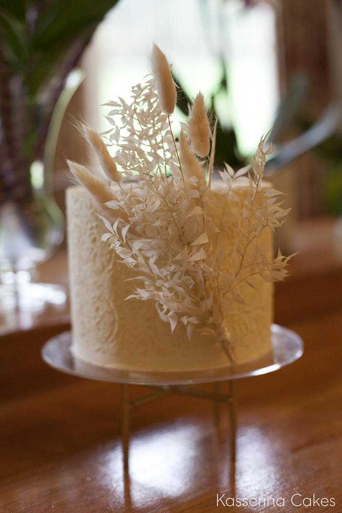 Buttercream cake with stencil detail and dried foliage