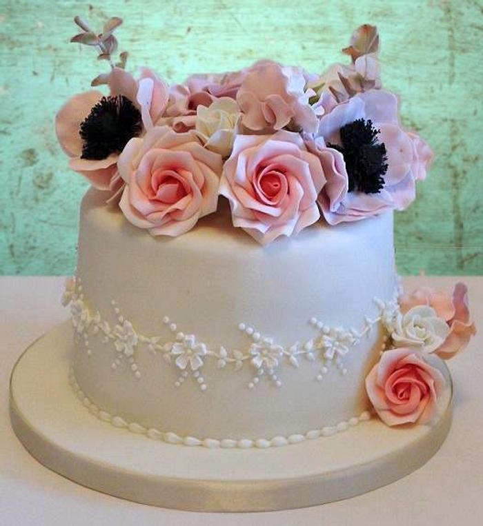 Birthday cake with piping and sugar flowers