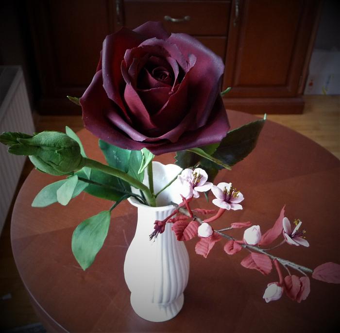 Dark red rose with a bud, cherry blossom branch, ruscus leaves from sugar paste 