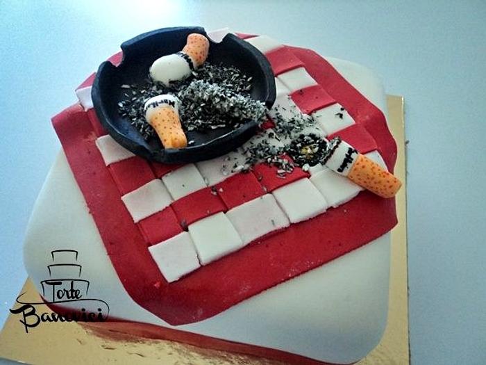 Cigarette on a table cake