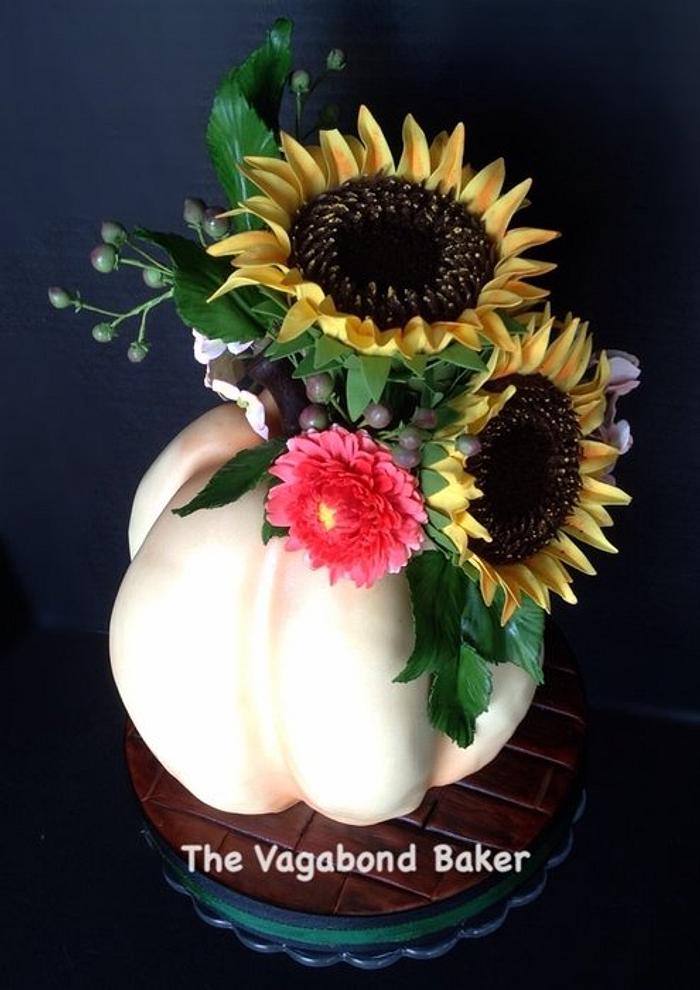 Thanksgiving pumpkin cake with sunflowers and mums