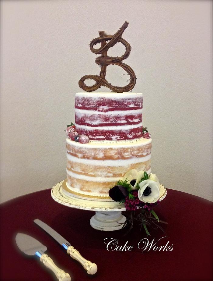 Naked cake with berries and anemone