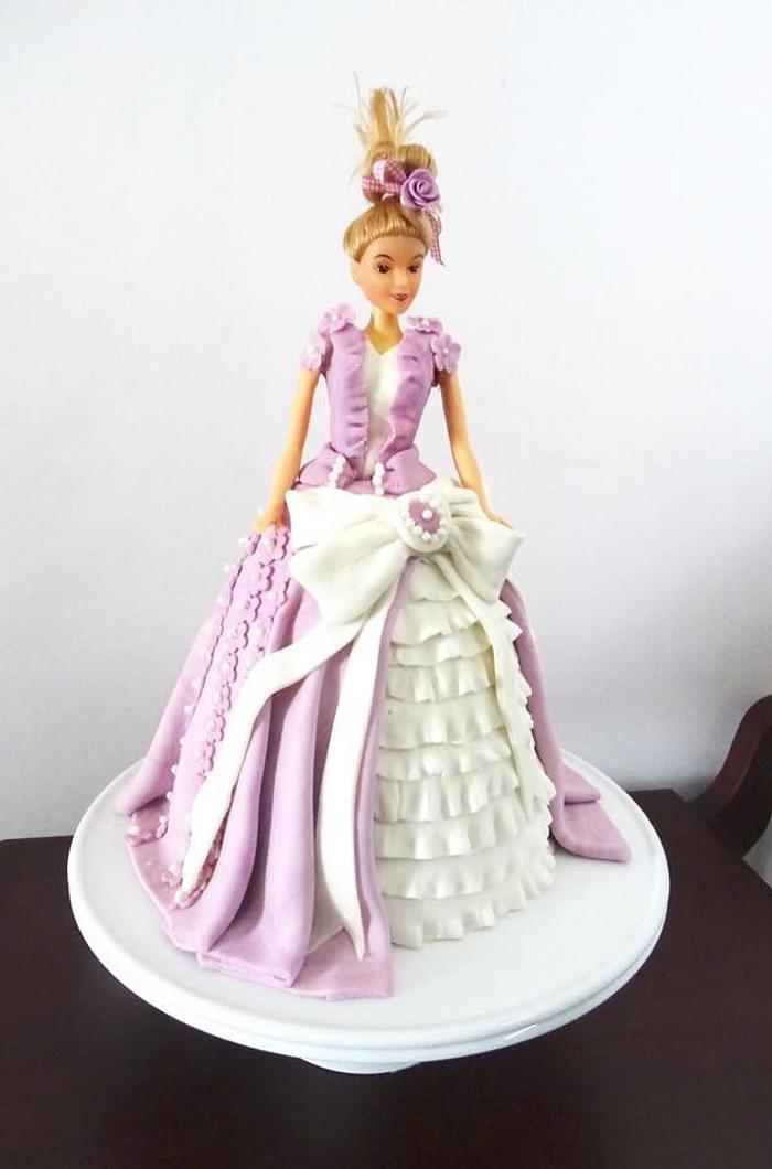 A prices cake with ruffles on her dress 