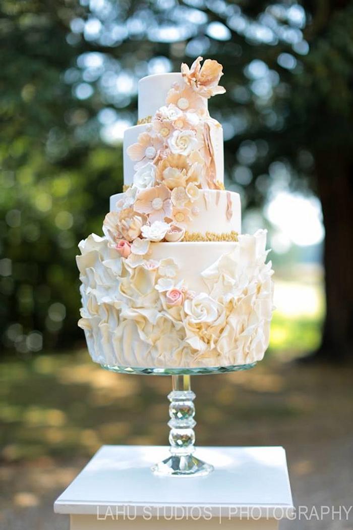 Blush, ruffles and flowers wedding cake