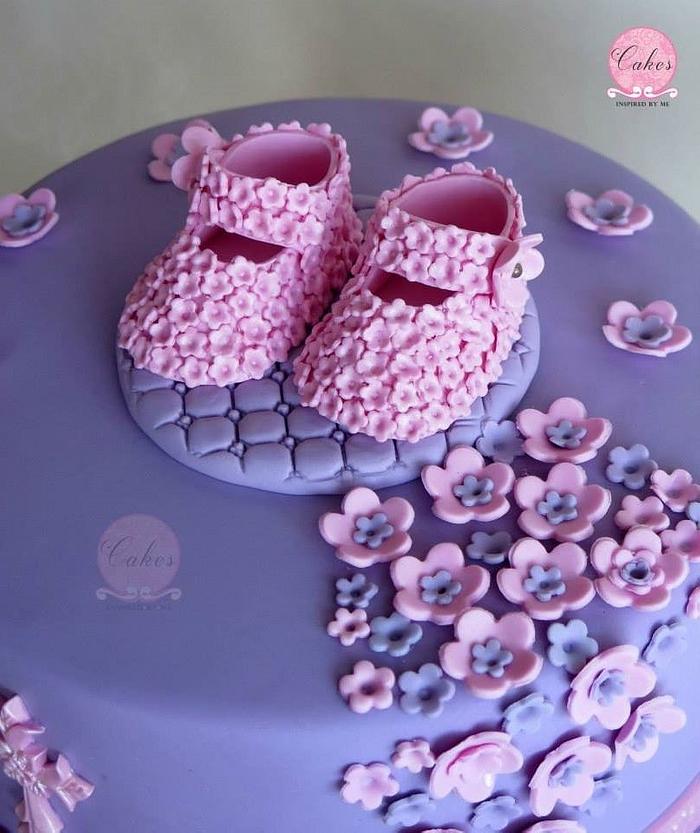 Pink and purple baptism cake with baby booties