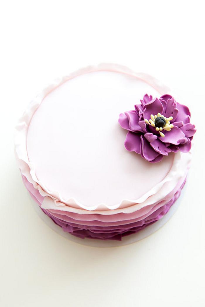 Purple ruffle cake with poppy flower