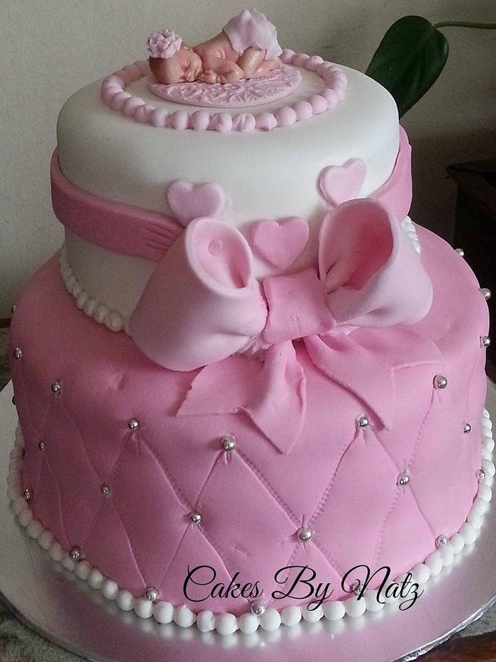 Pink and white baby shower cake