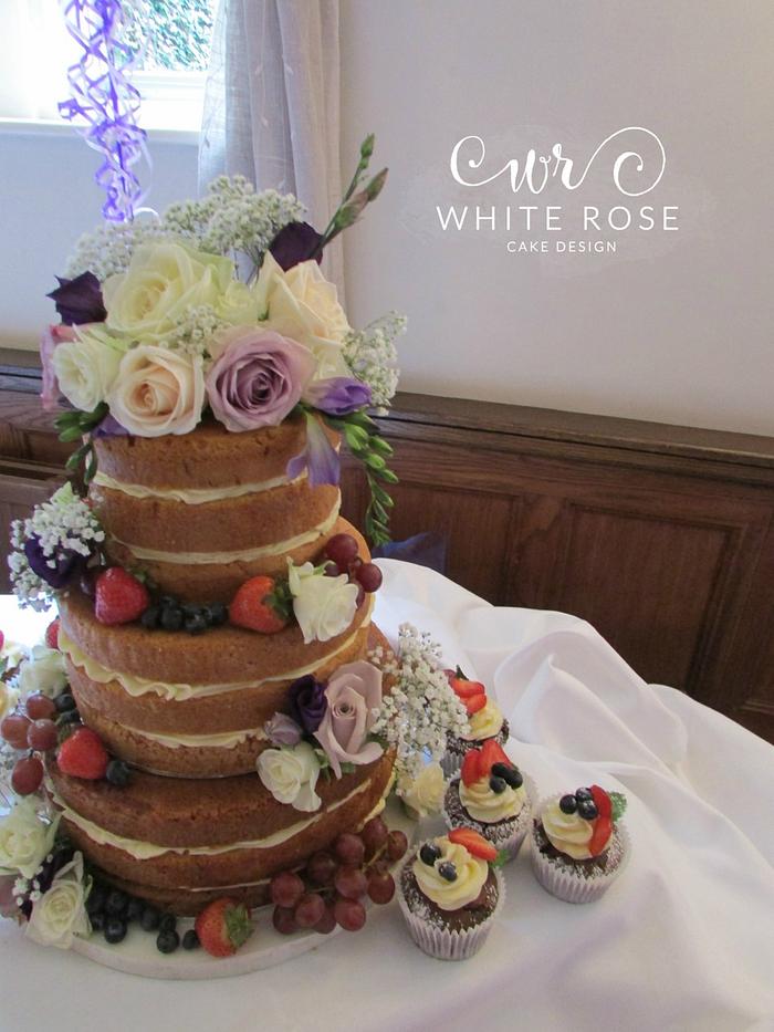 Naked cake with fresh flowers and berries