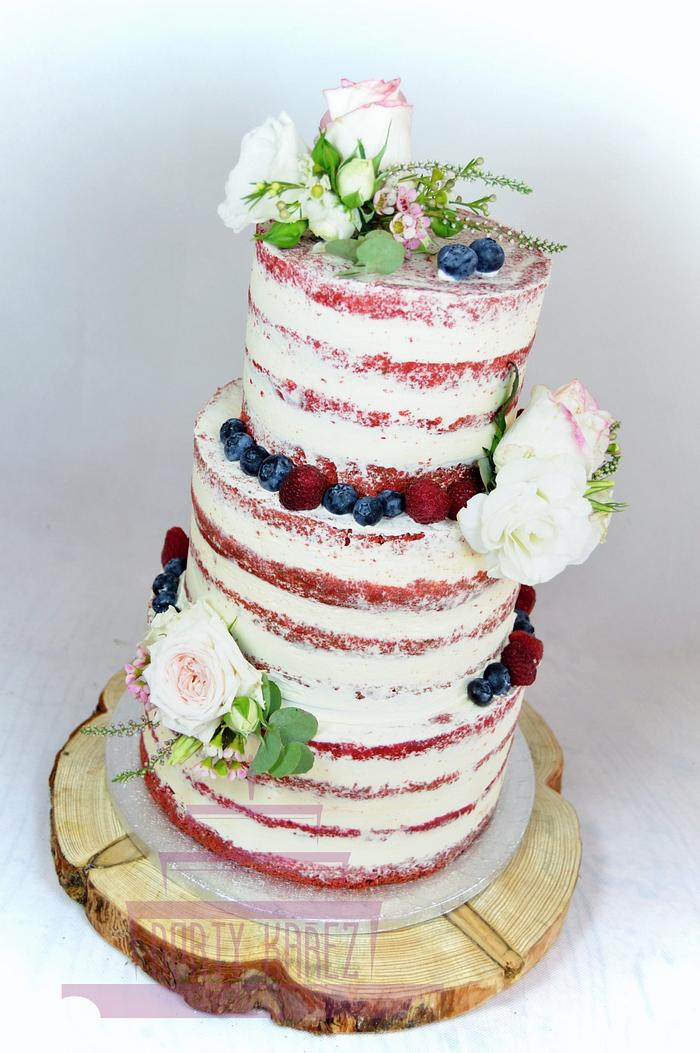 Semi naked wedding cake with furit and flowers