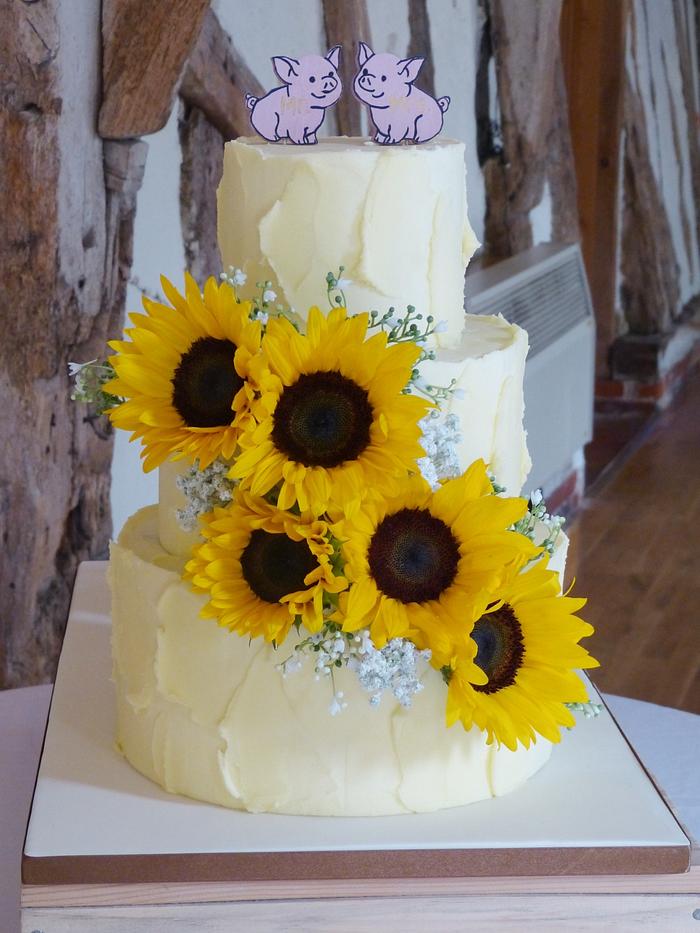 Rustic buttercream sunflower tractor mud wedding cake