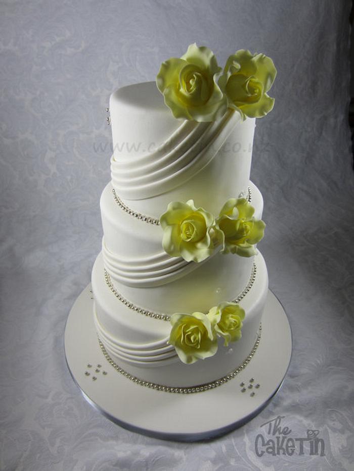 Yellow Roses and Fabric Drapes Wedding cake