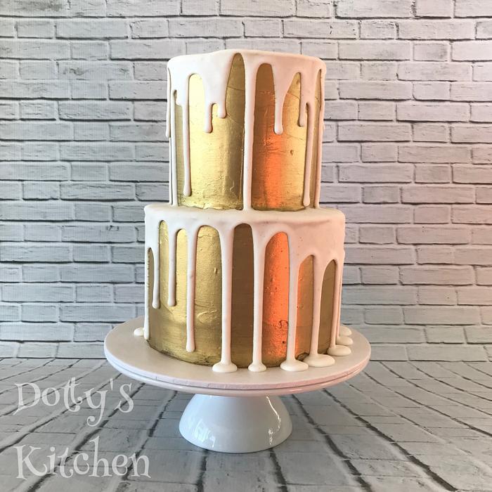 Gold painted cake with royal icing drip