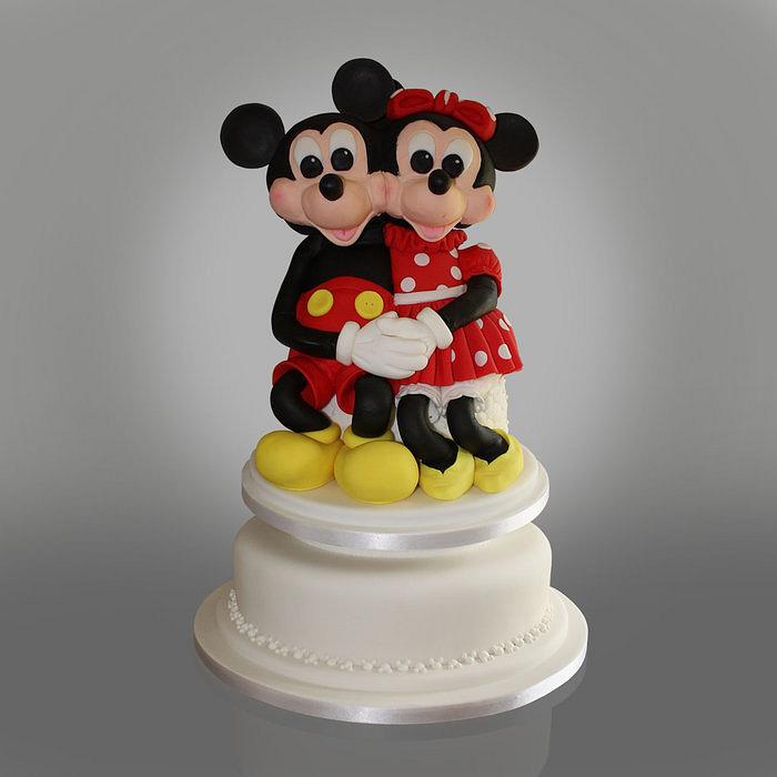 Minnie & Mickey sitting on a cake