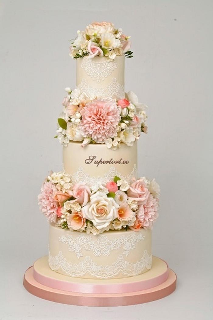 Floral wedding cake with peonies, roses, hydrangea and freesias