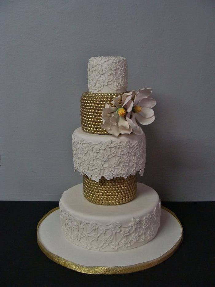 Magnolia and gold wedding cake