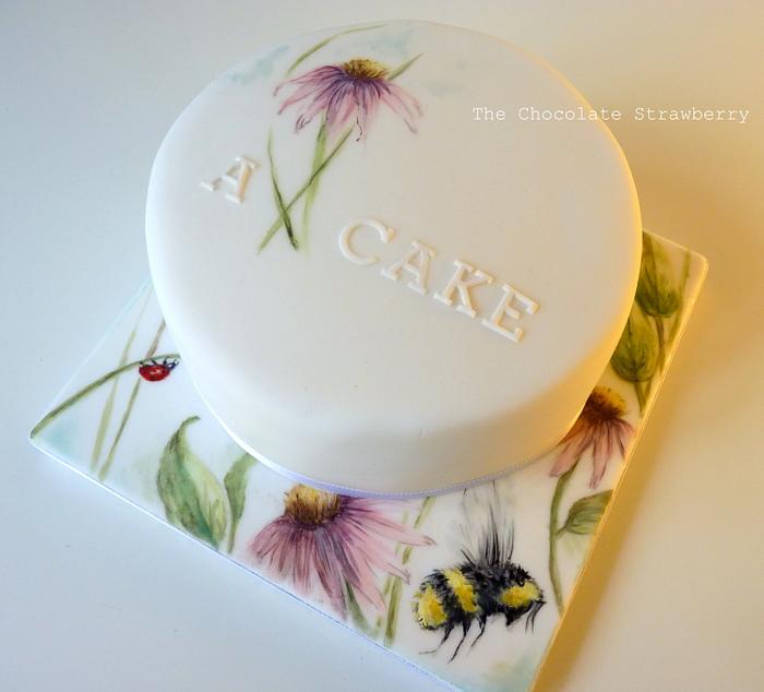 Hand-painted cake with flowers and insects