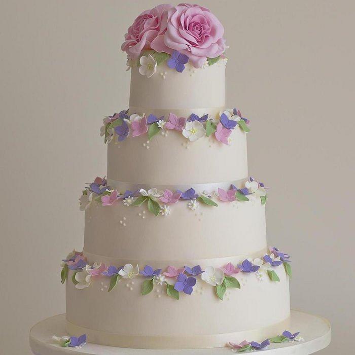 Pink rose bloom and hydrangea wedding cake