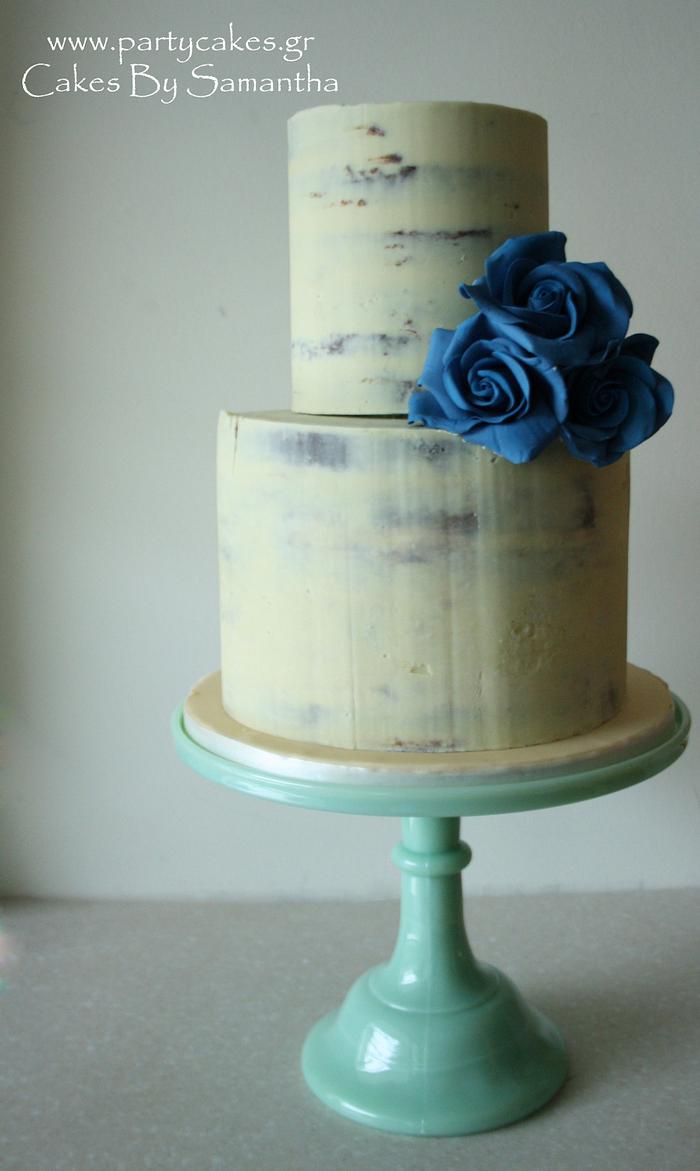 Simple semi-naked cake with blue roses