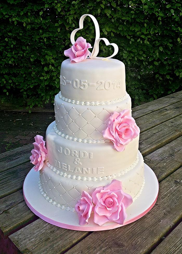 White wedding cake with pink roses