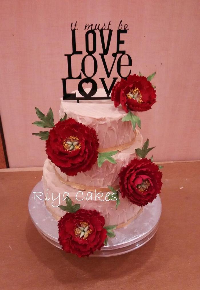 Red peonies engagement cake