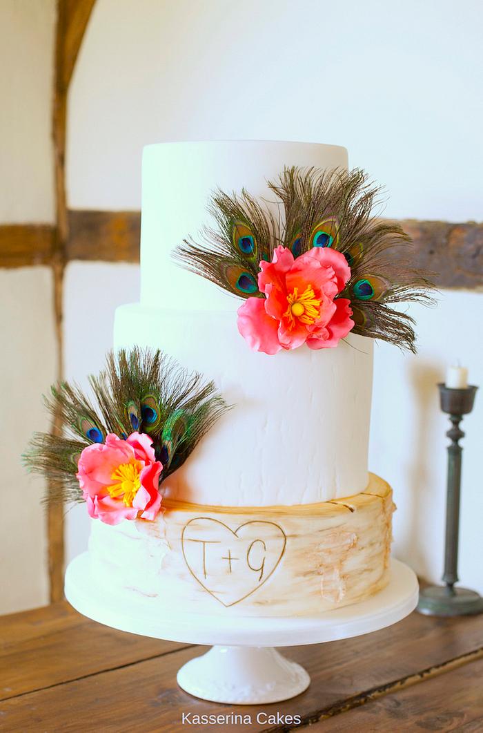 Peacock feather, stylised wild rose and birch log wedding cake