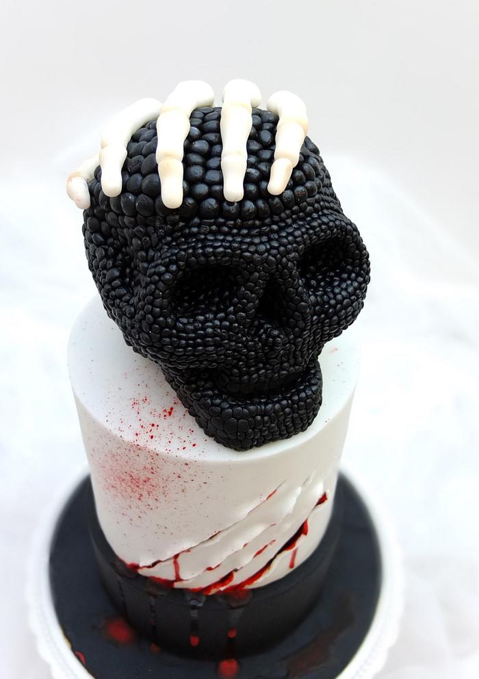 Skull cake and skeleton hand.