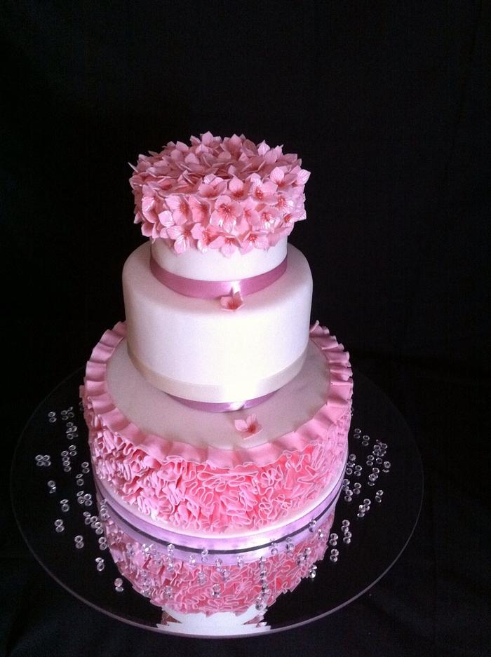 Pink ruffle and hydrangea wedding cake