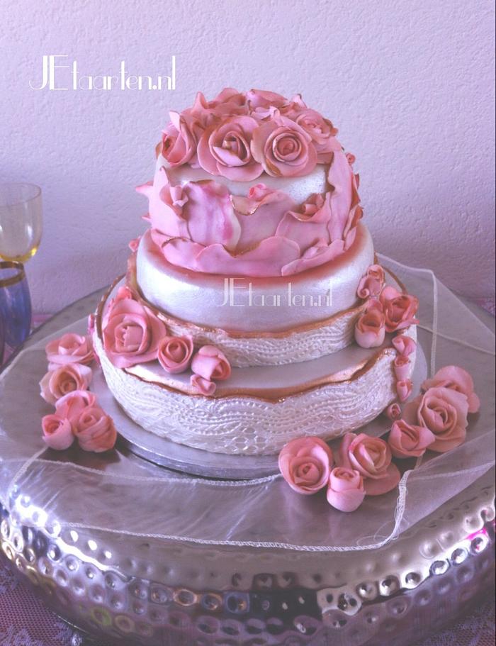 Pink wedding cake with roses and lace