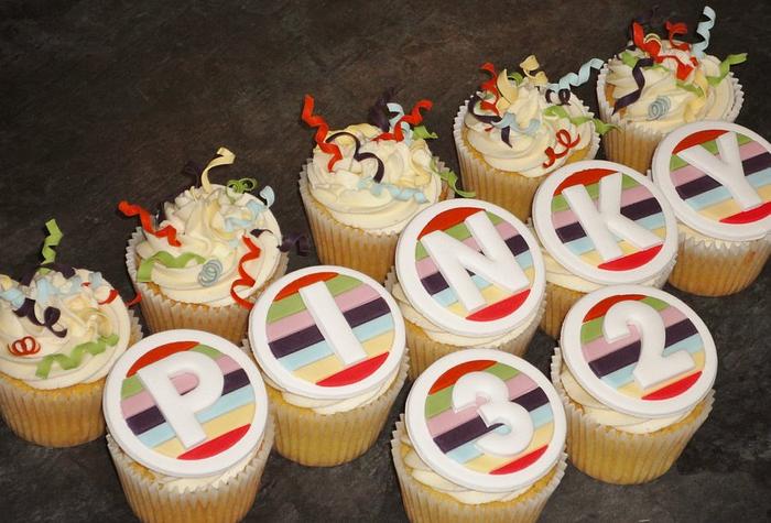 Birthday cupcakes with rainbow stripes and streamers