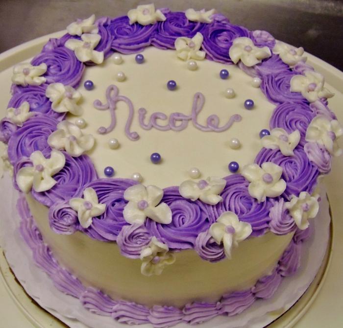 Purple rosette and white floral cake
