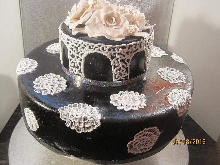 black anniversary cake with while sugarpaste roses