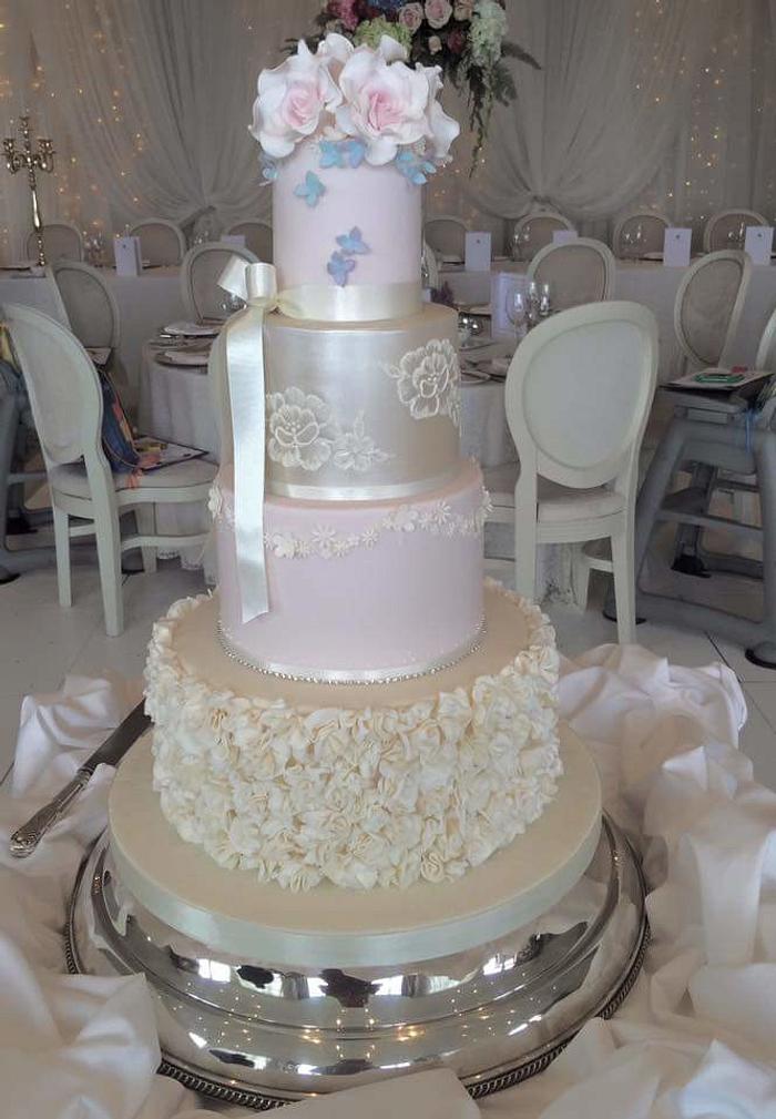 Wedding cake with flowers, bows and ruffles 