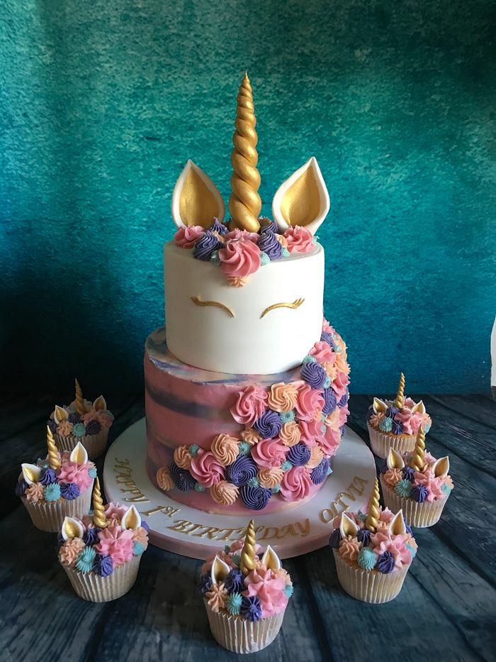 Tiered pastel unicorn cake and cupcakes 