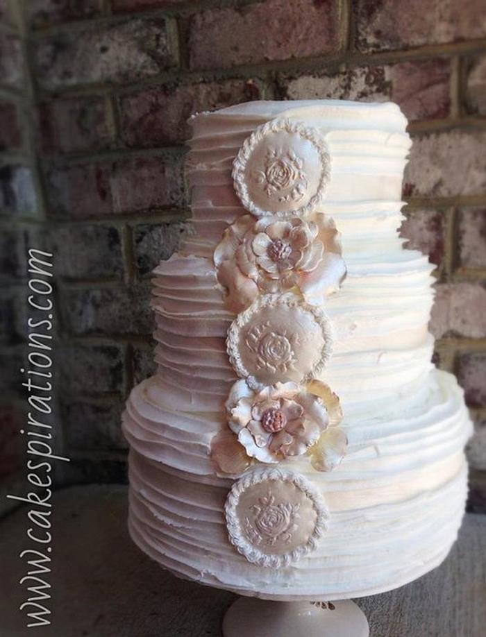 Ruffle wedding cake with rose medallions