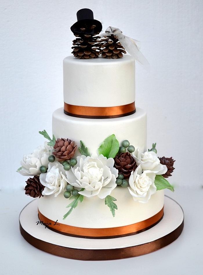 wedding cake with pine cones topper