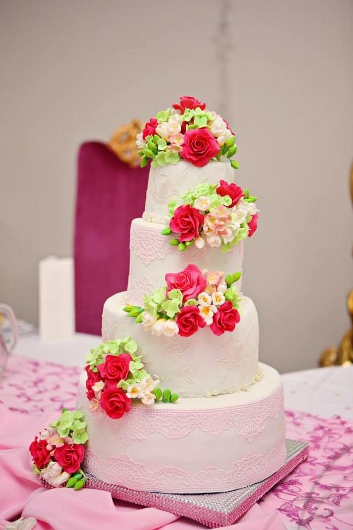 wedding cake with roses, freesias and hydrangea