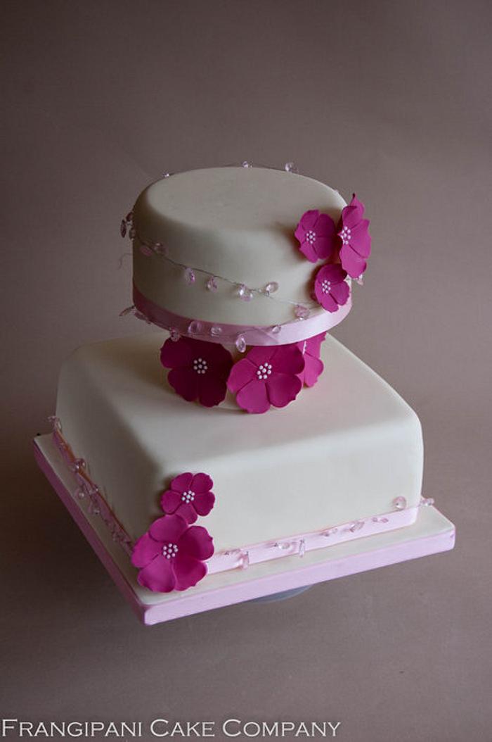 Three tiered ivory wedding cake with flowers