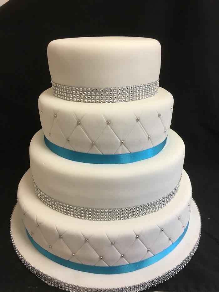 4 tier teal and diamanté wedding cake 