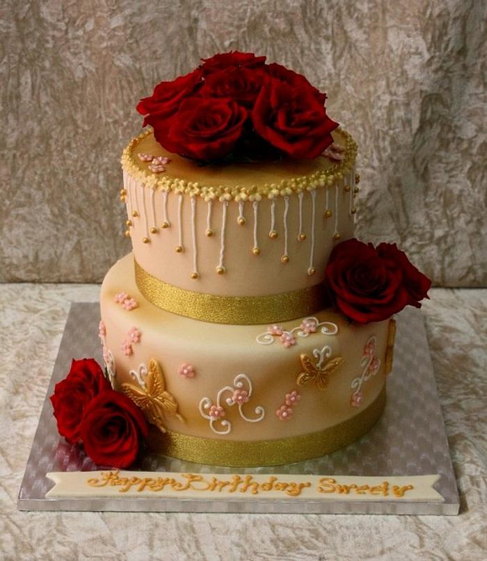 Golden cake with red roses