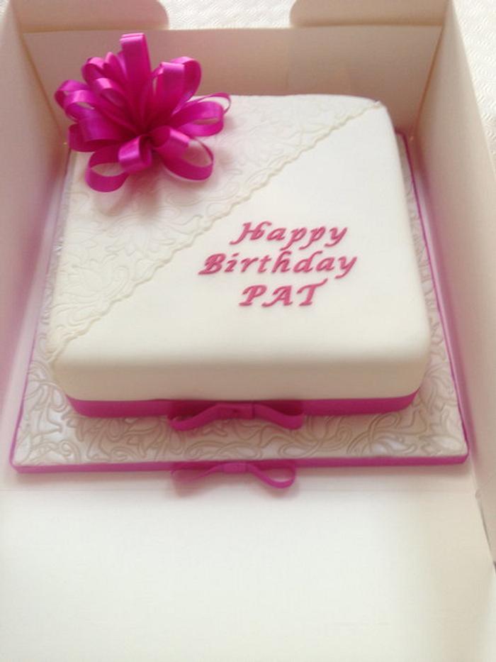 Plain but elegant birthday cake with fabric ribbon bow
