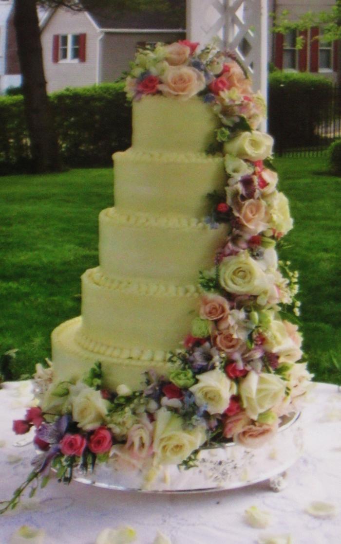 Buttercream wedding cake w/ cascading fresh flowers