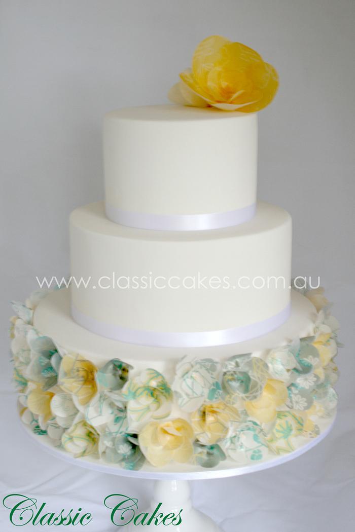 Yellow and teal floral wedding cake