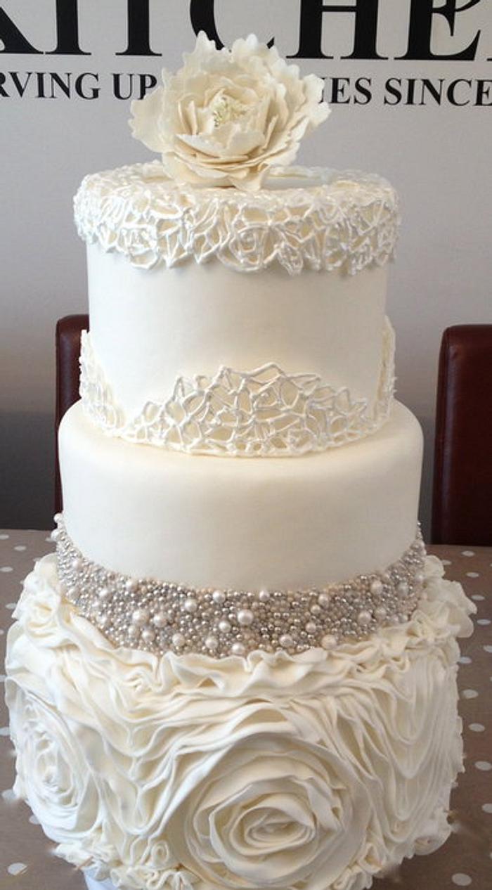 ruffles, edible bead encrusting, sugar peony and royal icing cage all on one cake!