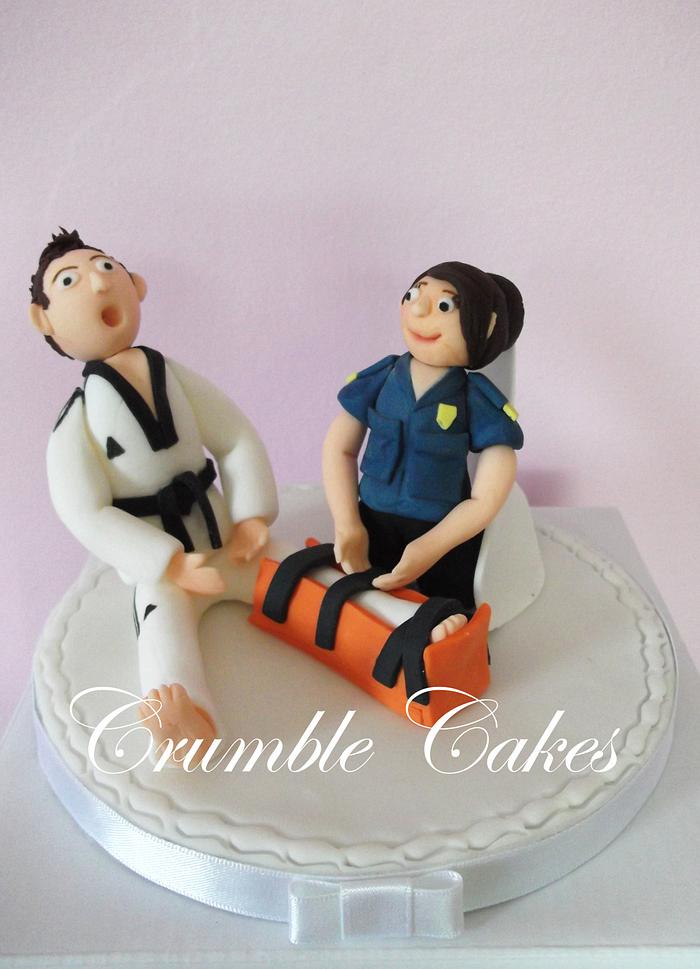 Cake topper for a paramedic bride and a karate instructor groom 