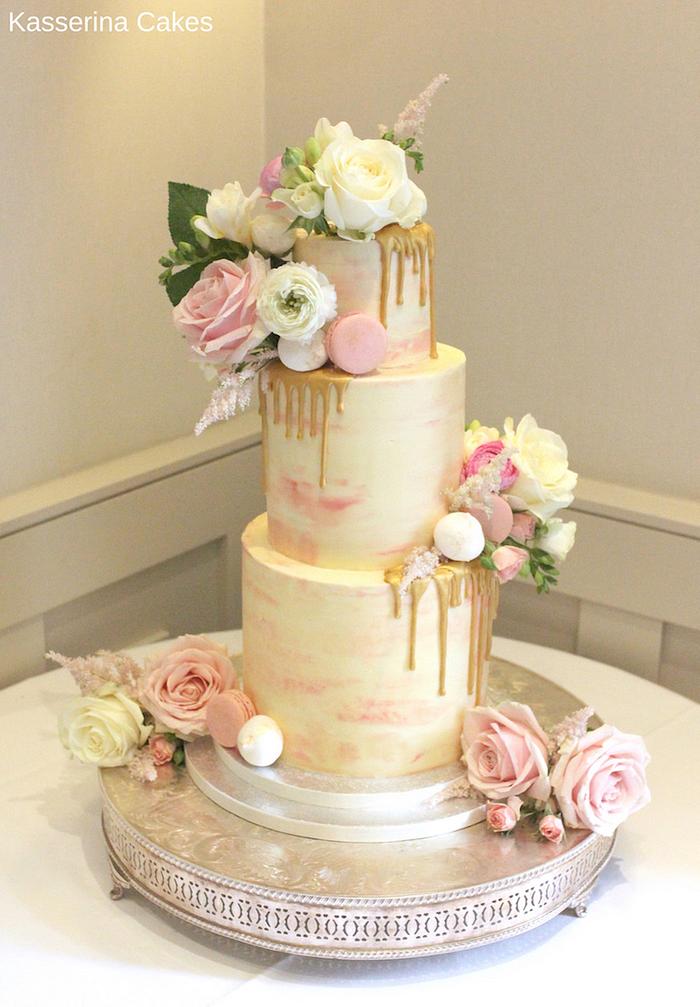 Watercolour effect buttercream cake with gold drip effect and fresh flowers